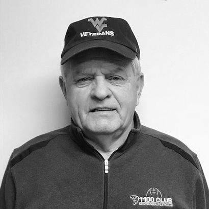 Black and white photo of terry keenan with Flying WV hat