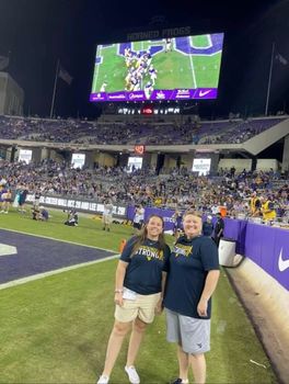 Two WVU fans on football field at TCU