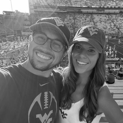 Black and white photo of Layne Veneri and wife at WVU football game.