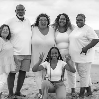 Black and white photo of the braxton family on the beach