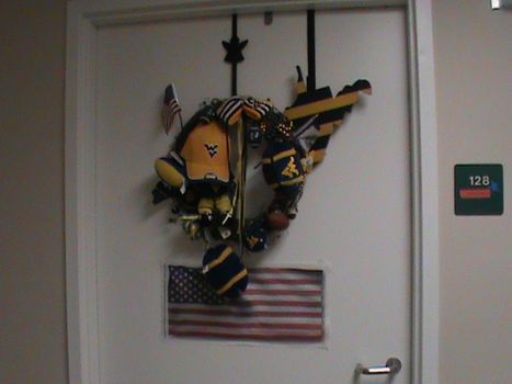 WVU door display with wreath, WVU hat and West Virginia state wall hanging