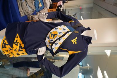 WVU Athleisure apparel on a mannequin with a WVU fanny pack